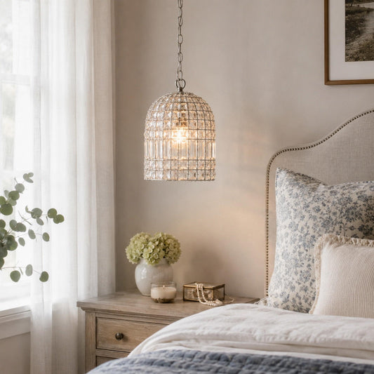 Clear crystal dome chandelier with chrome chain, emitting warm light.