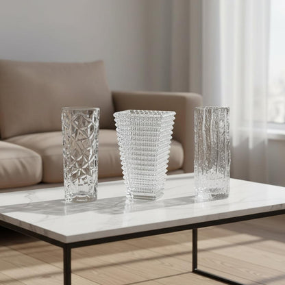 Three clear glass vases with faceted diamond and textured vertical-rib patterns