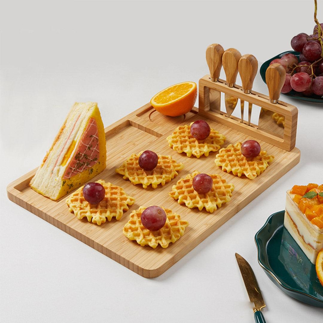 Rectangular wooden cheese board with knife rack and built-in tray for crackers and fruit