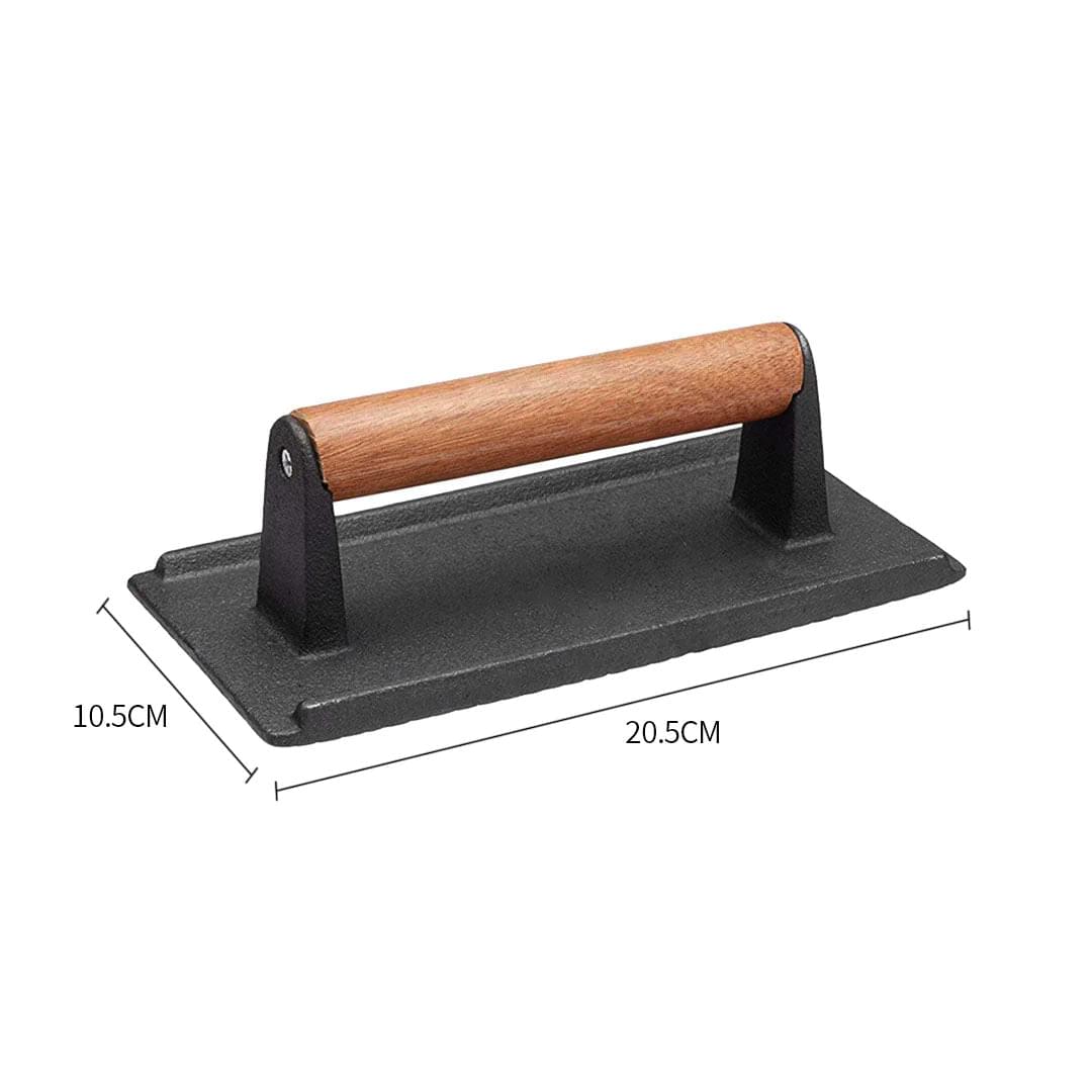 Cast iron bacon press with wooden handle; dimensions 20.5cm by 10.5cm