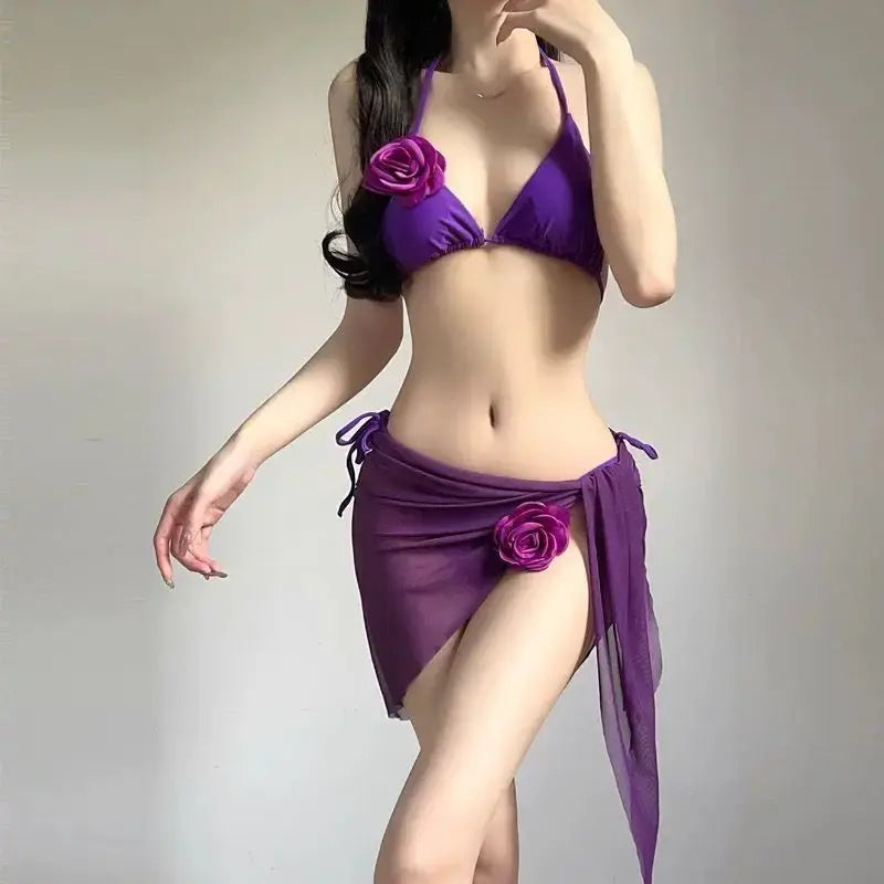 Purple strappy bikini set with triangle bra, rose accent, and tied sarong wrap