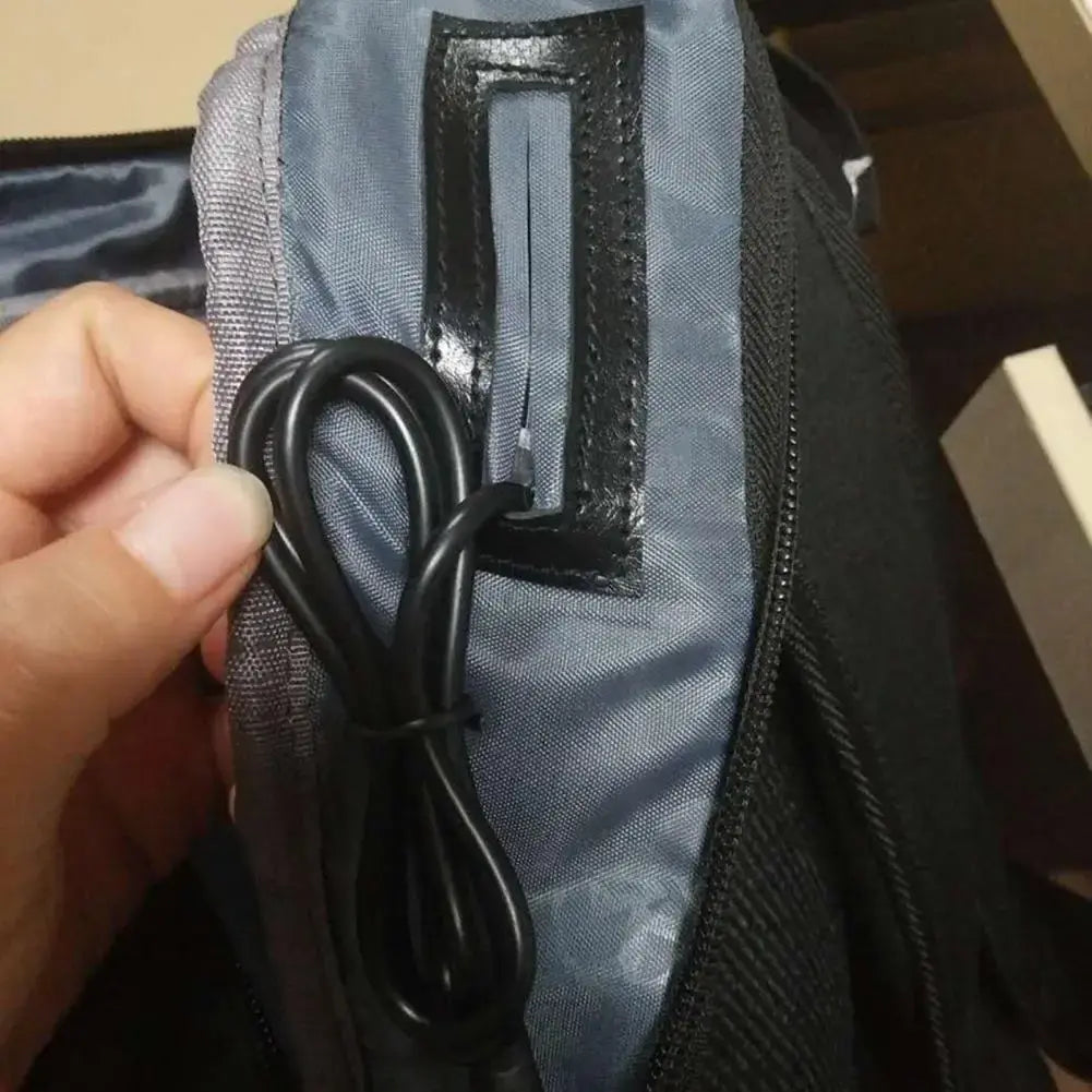 External charging cable module looped and tucked into backpack fabric pocket