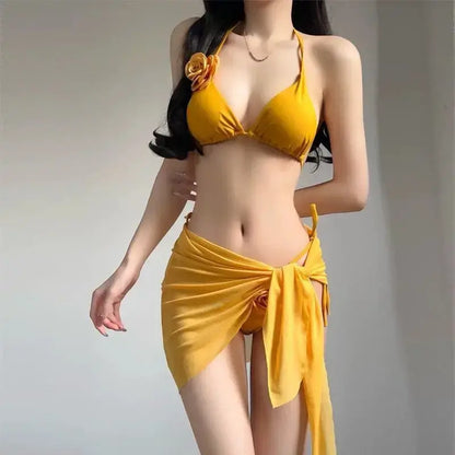 Yellow strappy bikini set with padded triangle top, rose detail, and draped wrap skirt