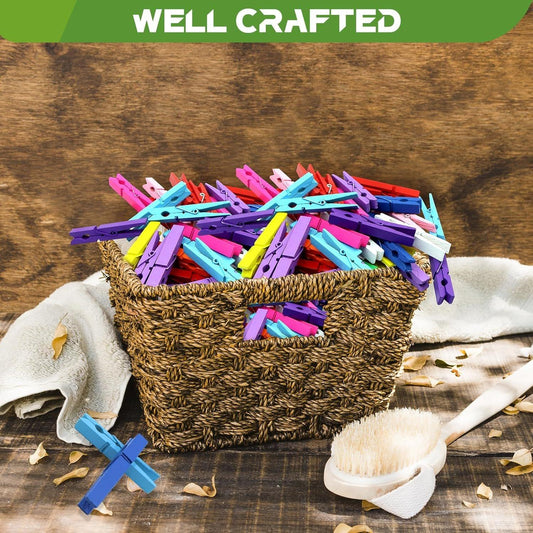 Colorful clothespins scattered on a woven basket with fabric and craft supplies
