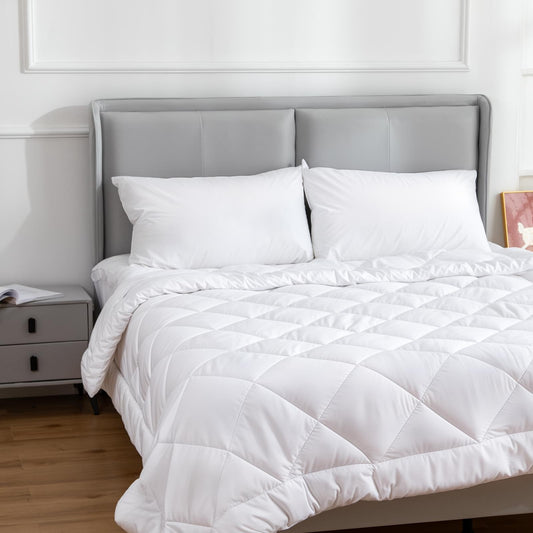 White cotton-covered pillow pair on bed, plush poly-filled cushions