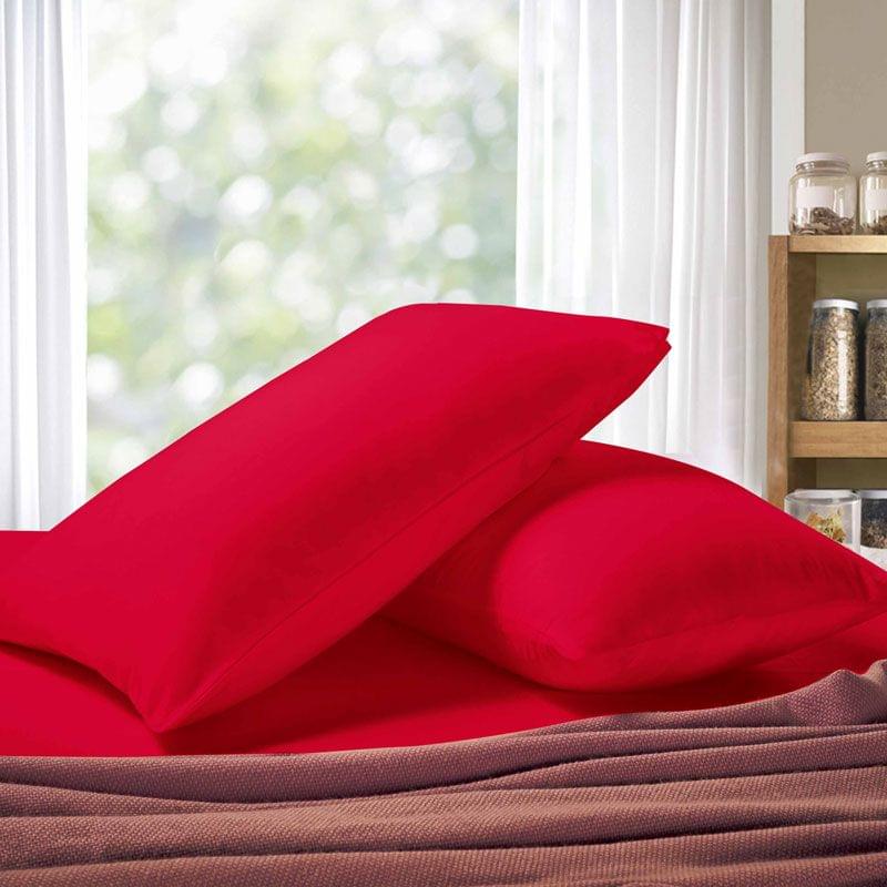 Red pillowcases with overlapping design, shown stacked with soft folds