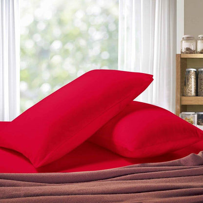 Red pillowcases with overlapping design, shown stacked with soft folds
