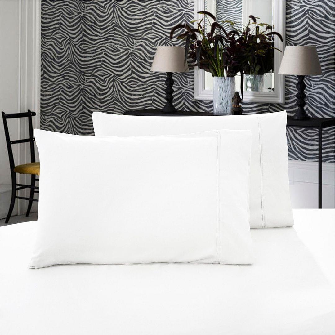 White standard pillowcases, two-pack, with smooth stitched seams on a bed
