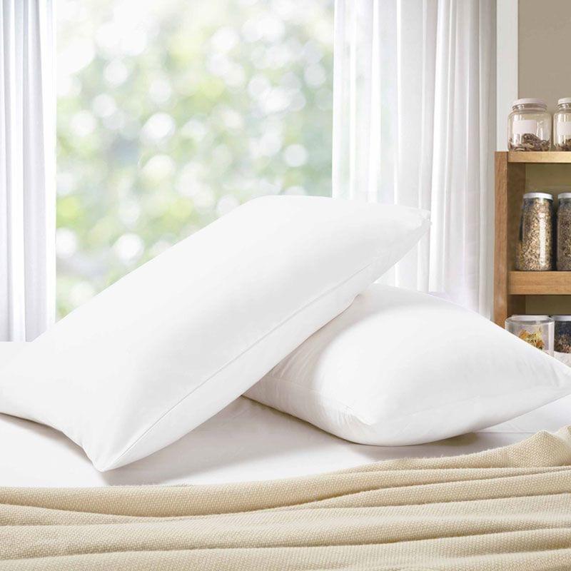 White standard pillowcase set on a bed, shown folded with neat stitched seams
