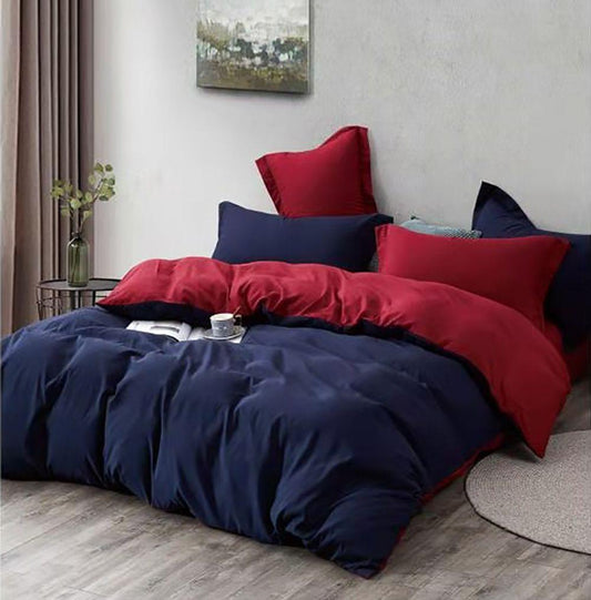 Reversible duvet cover set with navy blue and red layers plus three matching pillows