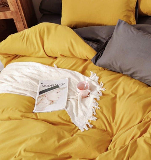Reversible duvet quilt cover showing yellow top and grey underside panels