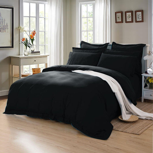 Black single duvet quilt cover set with matching pillowcases on bed