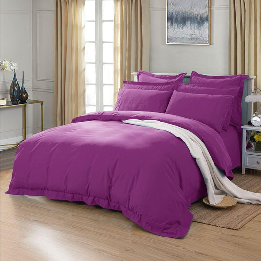 Purple duvet cover set on bed with matching pillow shams and draped throw