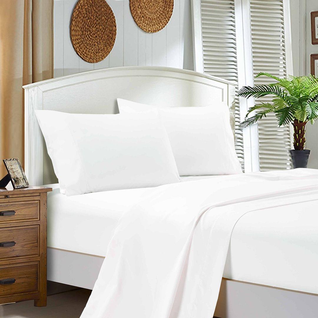 White bed sheet set with flat sheet, fitted sheet, and matching pillowcases