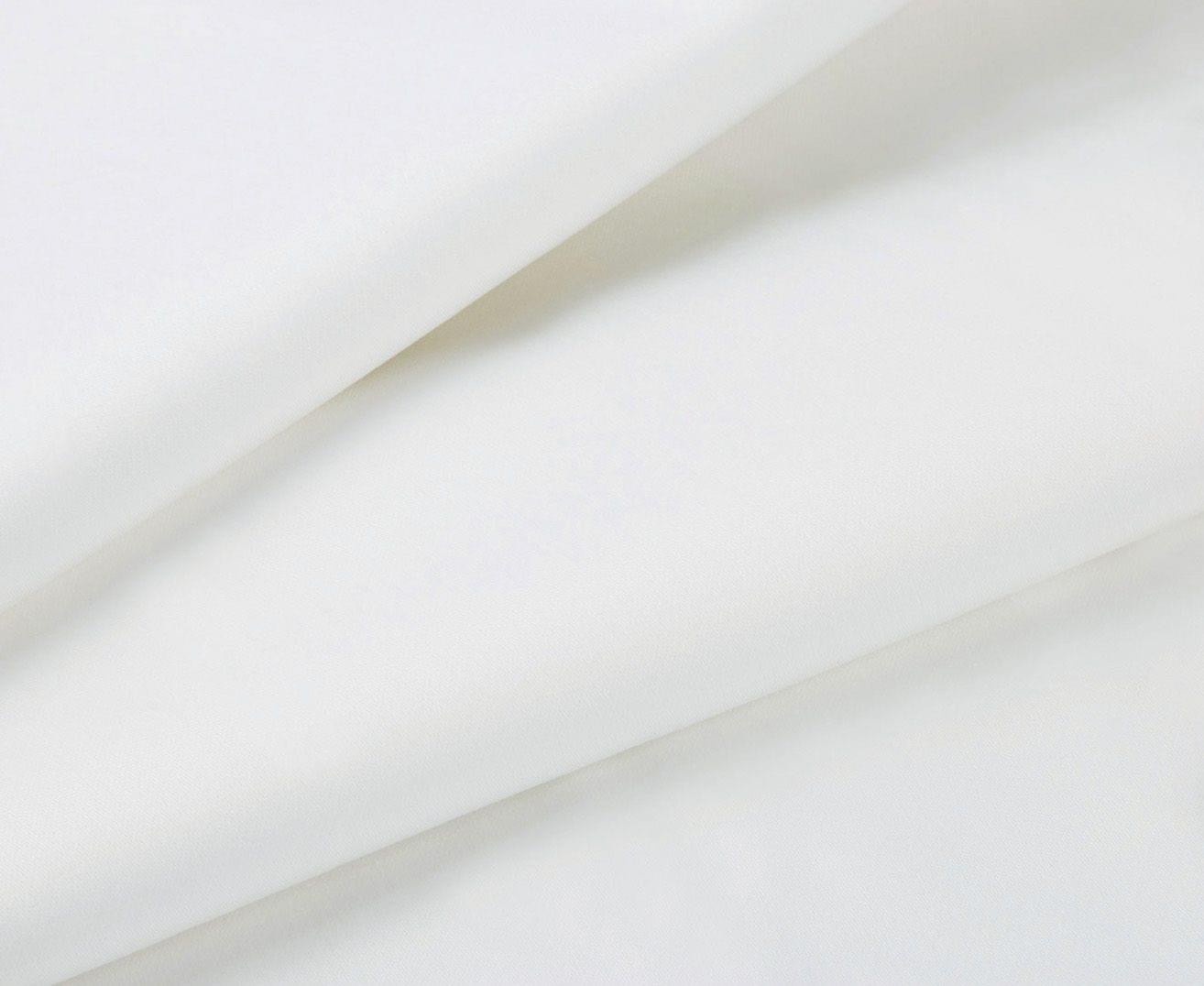 White flat bed sheet with smooth, wrinkle-free fabric close-up