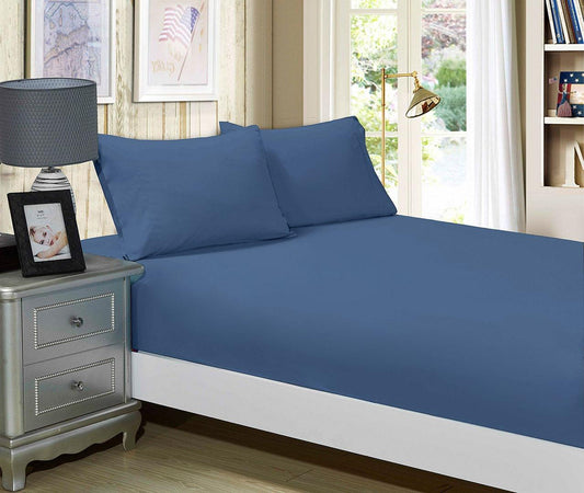 Greyish-blue fitted sheet and pillowcase set on king bed, folded linens