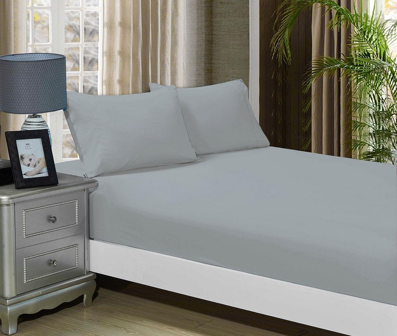 Silver fitted sheet and matching pillowcases set for king bed, shown on bed