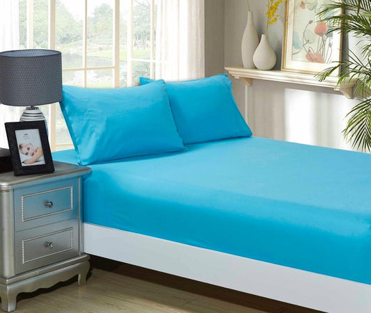 Light blue fitted sheet and matching pillowcase set on a bed, with two pillows