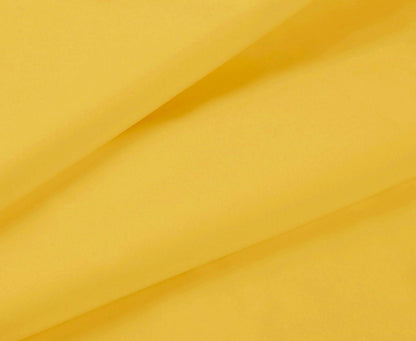 Yellow fabric close-up with draped folds from a fitted sheet