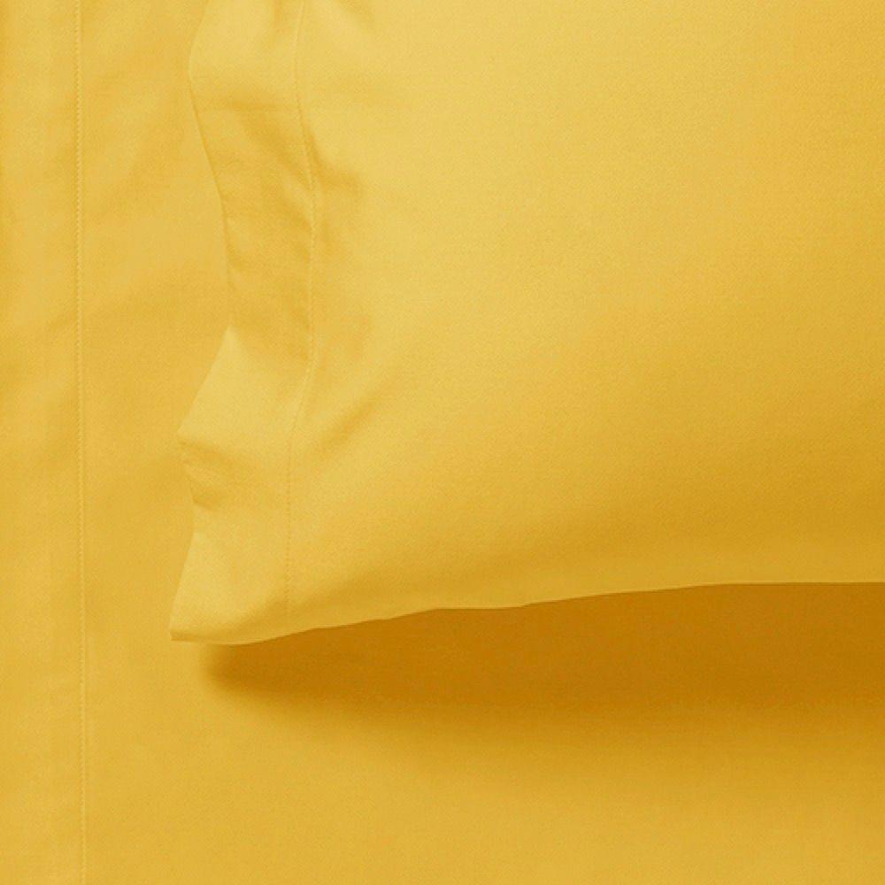 Yellow fitted sheet corner close-up with stitched seam and fold