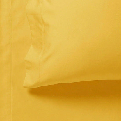 Yellow fitted sheet corner close-up with stitched seam and fold