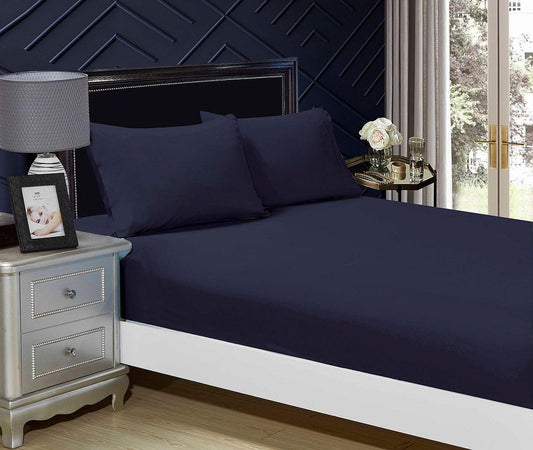 Midnight blue fitted sheet and pillowcase set on a single bed
