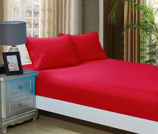 Red fitted sheet and matching pillowcase set on a single bed