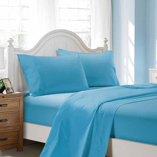 Light blue bed sheet set with flat sheet and pillowcases on a single bed