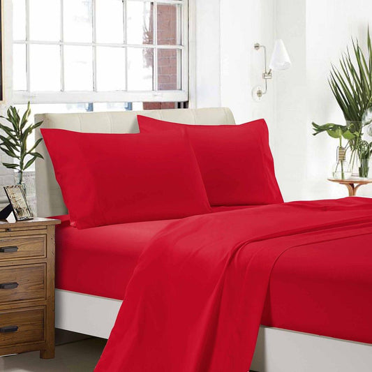 Red flat and fitted sheet set with matching pillowcases on a bed, red pillows