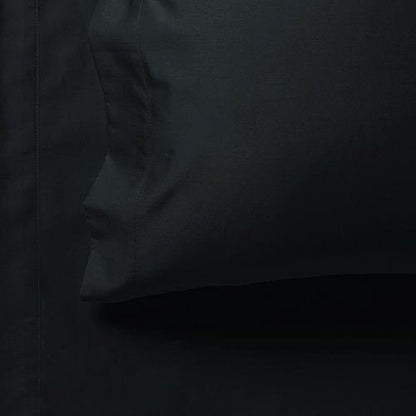 Dark fitted sheet corner with elastic seam detail, close-up