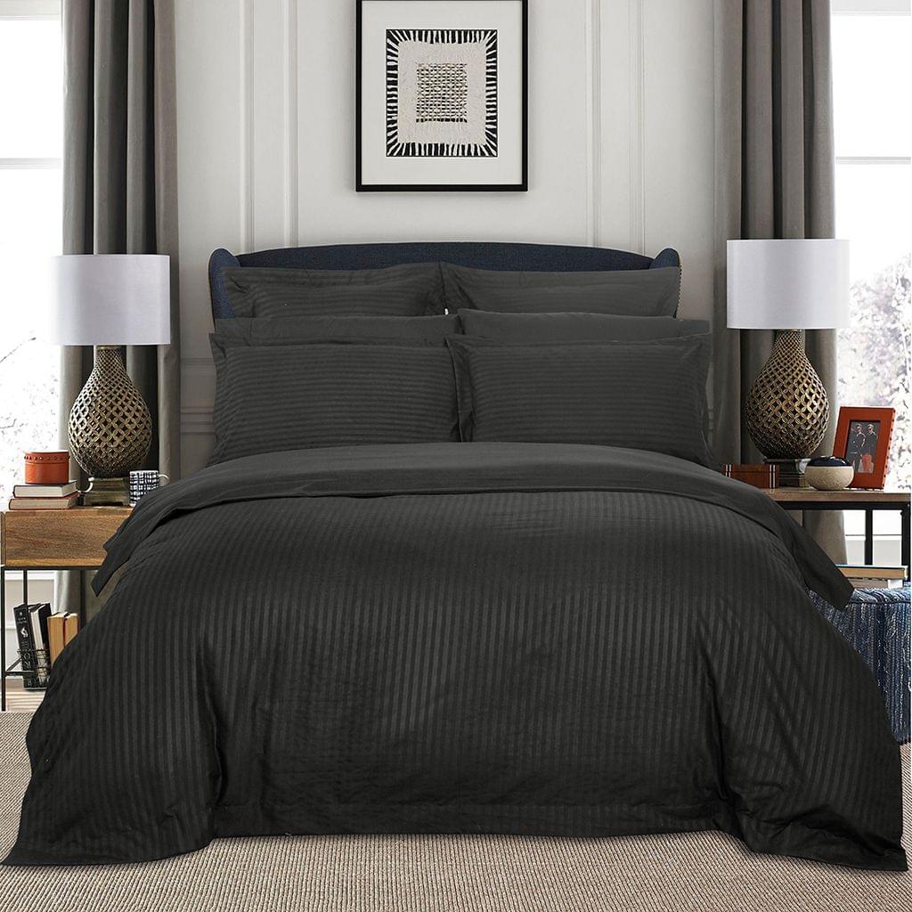 Charcoal striped king duvet quilt cover set on bed with coordinated pillow shams