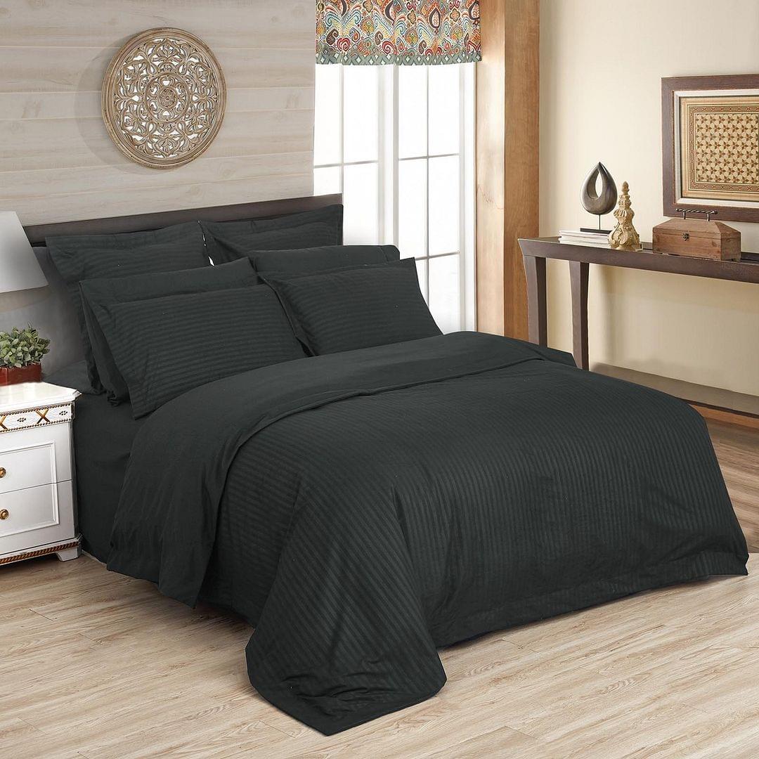 Charcoal striped duvet quilt cover set, king size, on bed with matching pillowcases
