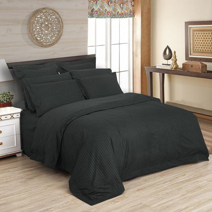 Charcoal striped duvet quilt cover set, king size, on bed with matching pillowcases