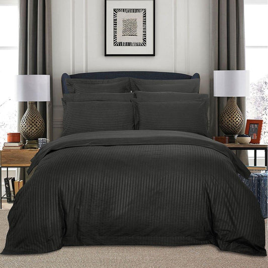 Charcoal striped super king duvet cover set with matching pillowcases, neatly styled on bed
