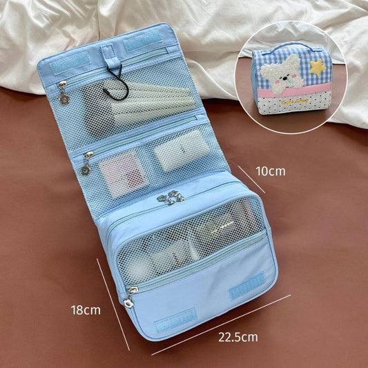 Blue open makeup bag with mesh pouches and divider pockets, labeled 22.5cm