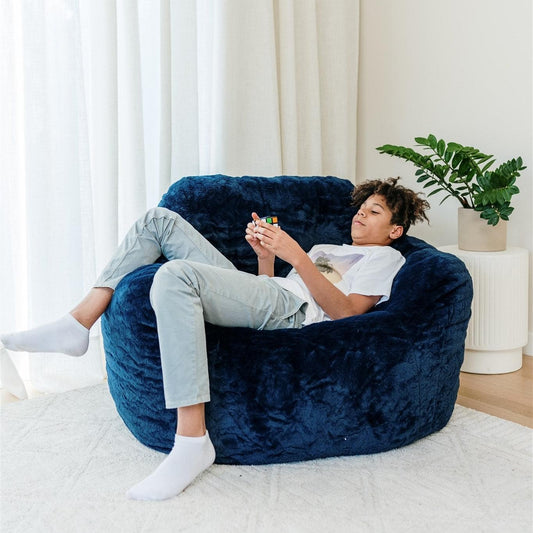 Navy blue oversized beanbag chair with deep seat and rounded backrest.