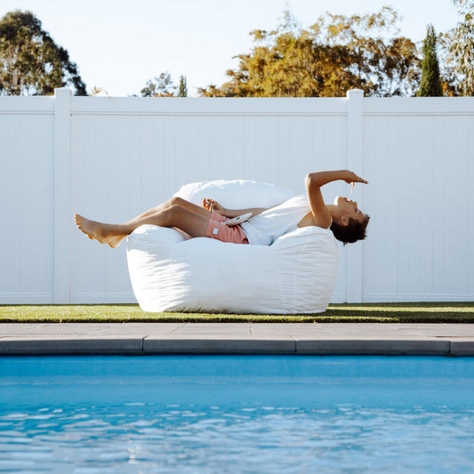 White Outdoor DreamPod bean bag chair, side view with deep cushioned seat.