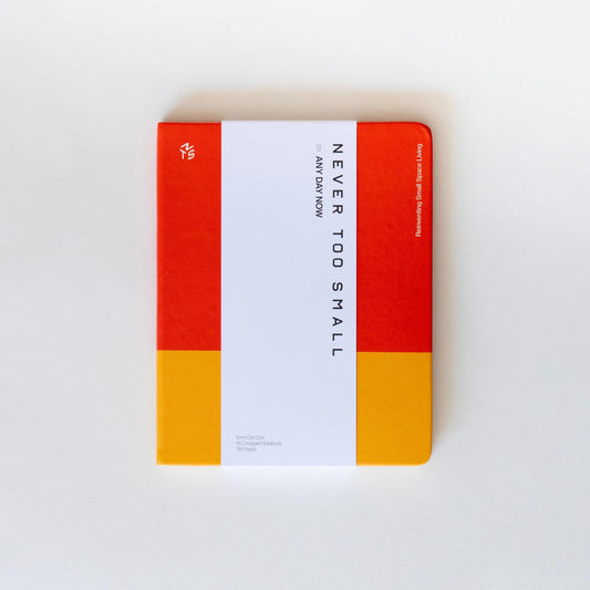 Red and yellow notebook cover with vertical title text, white paper inside