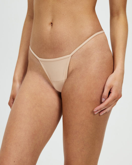Women's bone-colored mesh thong with thin strap sides