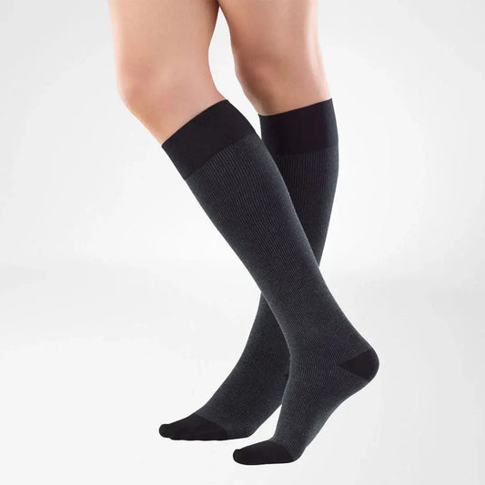 Black knee-high compression stockings with closed toe, worn to mid-calf