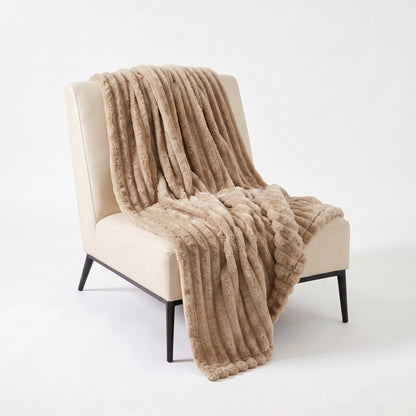 Light coffee flannel throw blanket with vertical ribbed texture, draped over chair