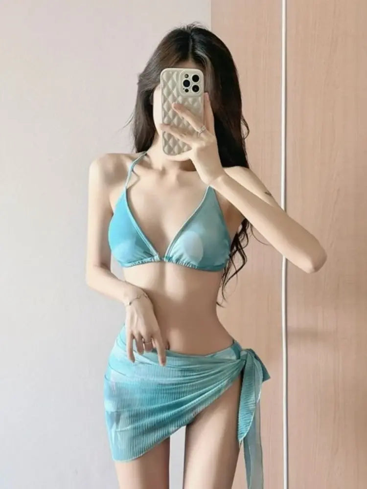Blue ribbed two-piece swimsuit with triangle bikini top and wrap mini skirt with tied hem