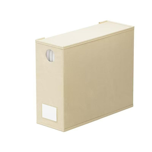 Beige fabric storage bin with oval side handle and front label window.