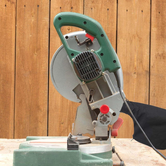 Black dust collection bag attached to a miter saw with fabric outlet