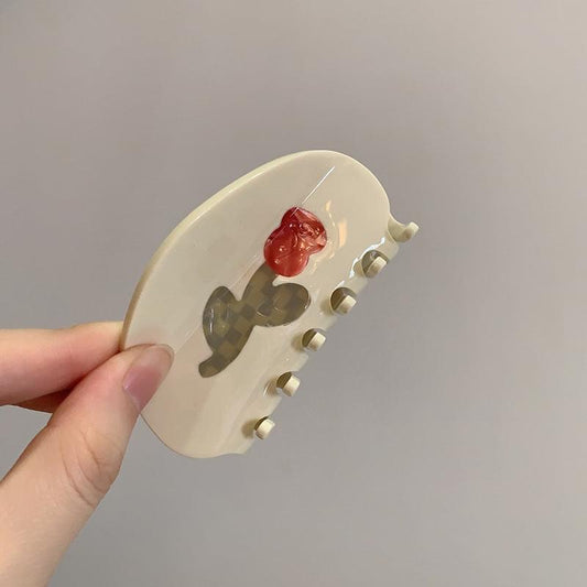 Medium white hair claw clip with red rose flower detail and curved teeth