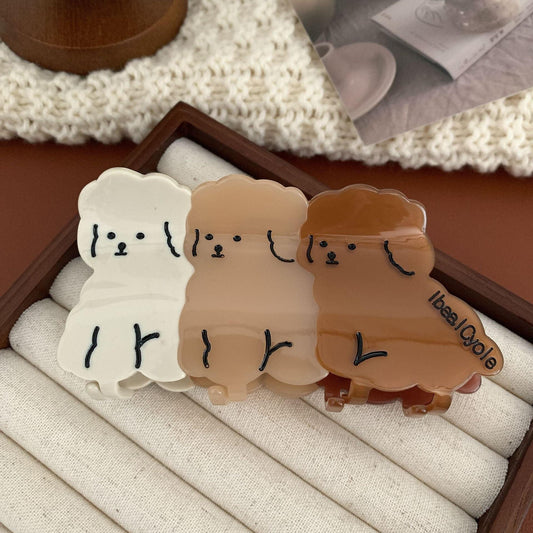 Set of cartoon dog hair claw clips, white to brown gradient faces