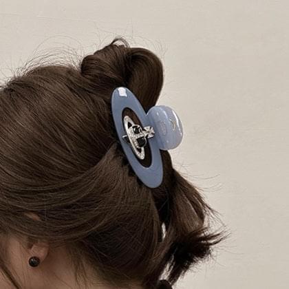 Medium hair claw clip with blue oval acetate and a silver diamond-style centerpiece