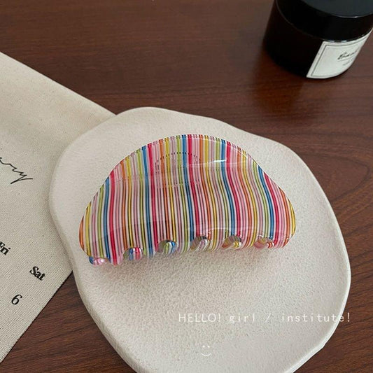 Medium acrylic rainbow stripe hair claw clip with curved teeth