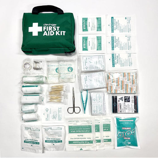 Green first aid kit bag with contents laid out in labeled packets