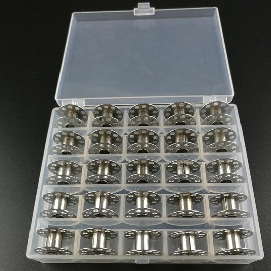 Silver sewing machine bobbins in clear storage box with multiple compartments